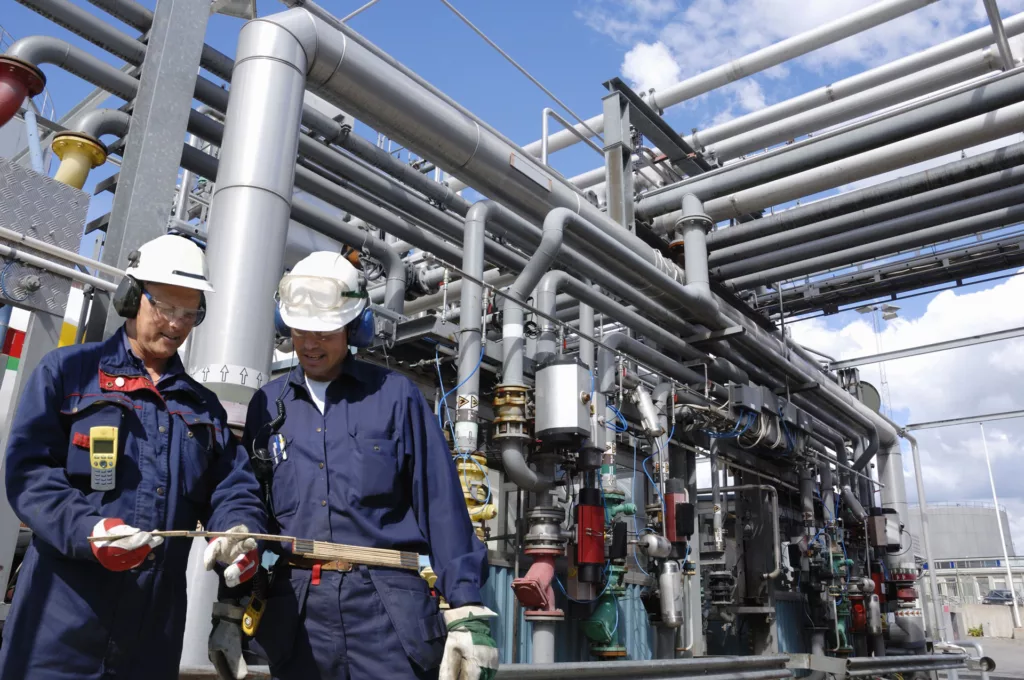 Two engineers standing in front of chemical plant
