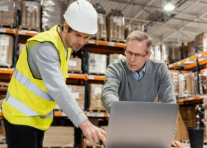 CEO discussing with employee about distribution ERP system