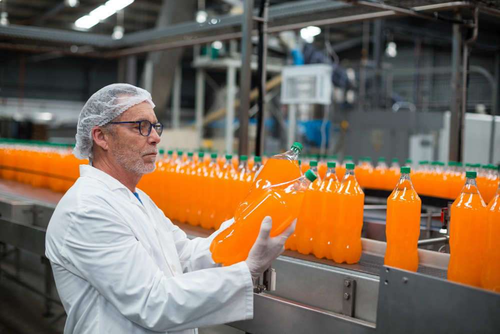 A food and distribution company employee reviewing quality of the beverage - Understanding ERP in Distribution for Food and Beverage