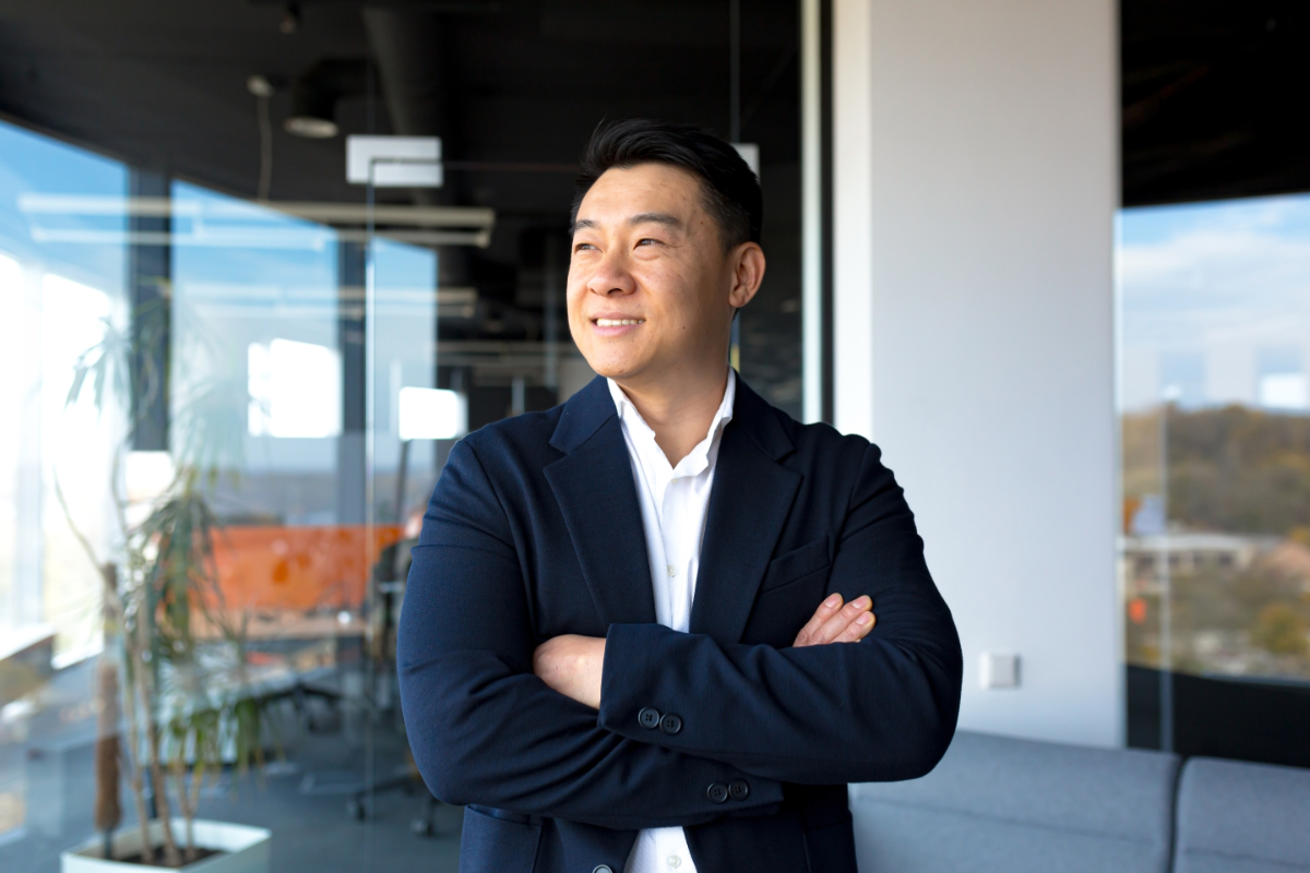 Portrait of successful business owner male boss asian cheerful happy smiling and rejoicing in modern office by big window - ERP Risk Management Strategies for Business Success